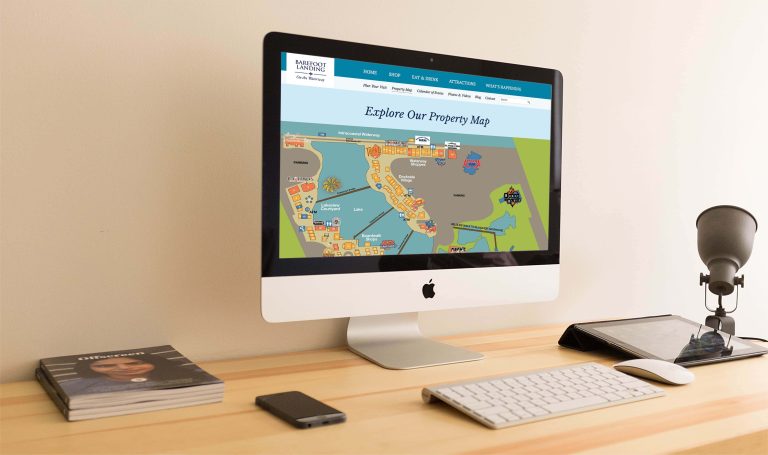 Barefoot Landing website on desk